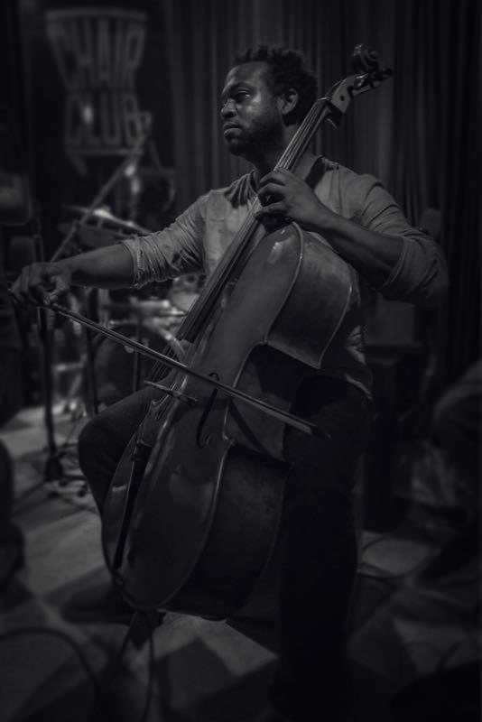 RAHAM playing cello, in black and white