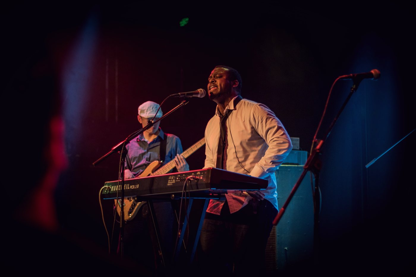 RAHAM performing on stage with a guitarist
